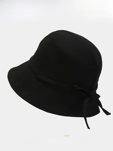 Close-up of bow tie detail on a foldable sun hat with four color options below
