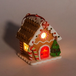 Detailed view of illuminated brown gingerbread house hanging ornament with festive LED lights