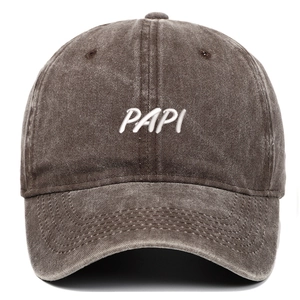 Detail showing white 3D embroidery on washed coffee-colored cotton baseball cap fabric