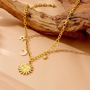 Gold chunky necklace with sun moon star and heart charms on a rustic wood stand