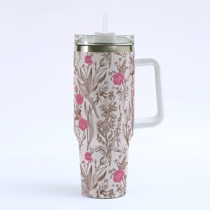 Detail of pink 40oz stainless steel tumbler featuring brown floral 3D prints and handle