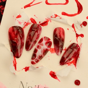 Short almond press-on nails with 3D red blood marble patterns for Halloween horror theme