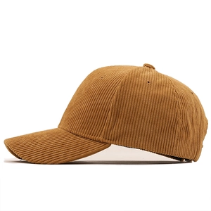 Detailed side view of brown corduroy baseball cap showing retro ribbed fabric texture
