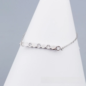 Close-up of silver geometric hexagon bracelet featuring shimmering cubic zirconia stones