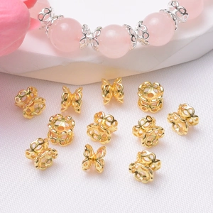 Detailed macro view of 14K gold plated hollow floral spacers for DIY jewelry making