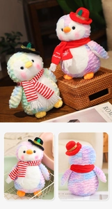 Detail view of colorful tie-dye plush penguins with Merry Christmas scarves and hats