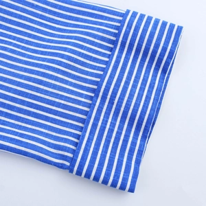 Detail of blue and white striped cuff showing high-quality cotton linen fabric texture