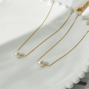 Minimalist 18K gold plated titanium steel necklace featuring a round white pearl pendant