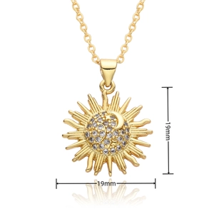 Detail view of a 19mm gold sun pendant necklace with cubic zirconia pave center