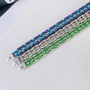 Detailed view of three stainless steel motorcycle chain bracelets in various colors