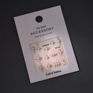Bronzing nail art stickers with pearls and star designs in white window packaging