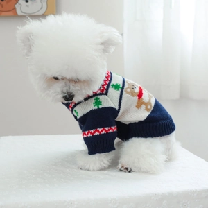 Close-up of a navy blue pet knit sweater featuring Christmas tree patterns and ribbed cuffs