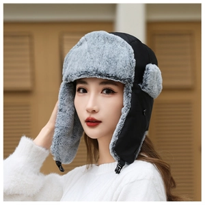 Detail of winter trapper hat featuring warm gray faux fur lining and chin buckle strap