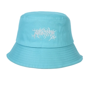 Detail of white gothic thorn embroidery on a sky blue cotton canvas bucket hat