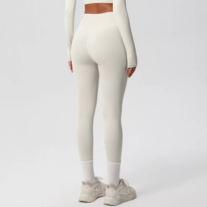 Detail of cream white yoga set showing seamless high-waist leggings and long sleeve cropped top