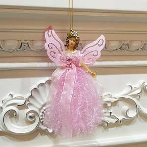 Detail of pink Christmas angel ornament with glittery resin body and lace fabric skirt
