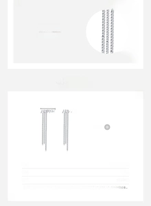 Détail macro de boucles d'oreilles pampilles en argent 925 avec lettrage HAPPY et specs