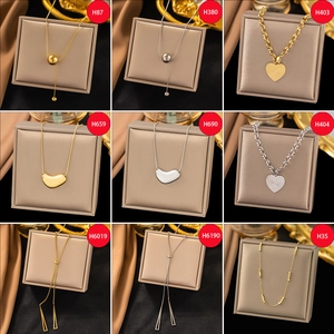 Collection of gold and silver titanium necklaces in diverse geometric and heart designs