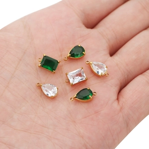 Golden stainless steel pendants with green and white zircon stones in various shapes
