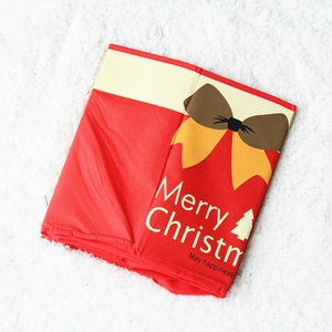 Close-up of red non-woven Christmas tree collar with Merry Christmas text on faux fur