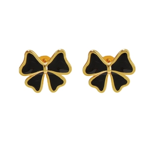 Élégantes boucles d'oreilles nœud plaquées or avec émail noir sur fond blanc