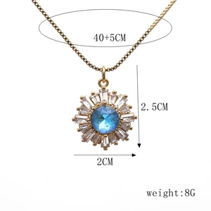 Detail of sunflower pendant size 2.5x2cm with blue stone and gold plated chain
