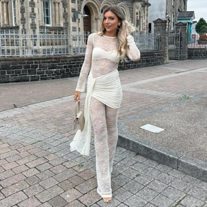 Close-up of white lace long sleeve top and matching pants set for women street style