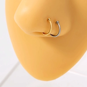 Minimalist U-shaped stainless steel nose rings in gold and silver finish on model