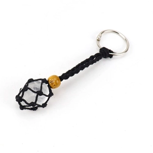 Detail of hand-woven black cord keychain with raw crystal stone in mesh net pouch
