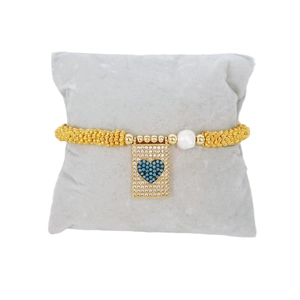 Bohemian gold beaded bracelet with turquoise heart pendant and a single pearl accent