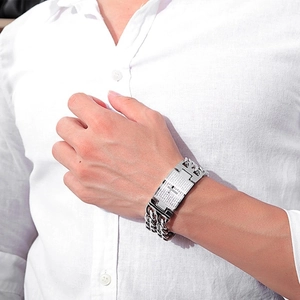 Detail of silver stainless steel double chain bracelet with engraved cross and scripture