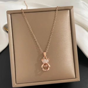 Detailed macro view of rose gold bear pendant with sparkling zircon micro-inlay
