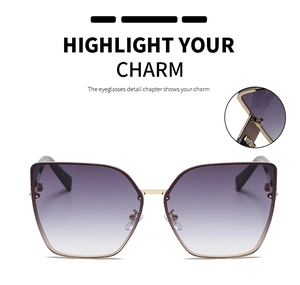 Detail of trendy cat eye sunglasses with purple gradient lenses and gold metal frames