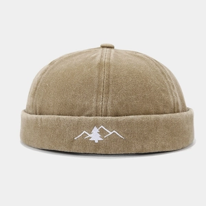 Detail of mountain embroidery on a vintage khaki washed cotton docker cap