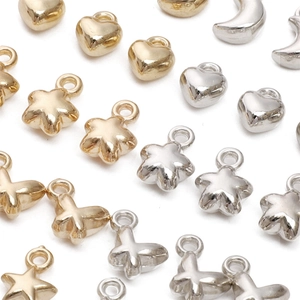 Detailed view of mixed gold and silver star, heart, and butterfly CCB plastic charms