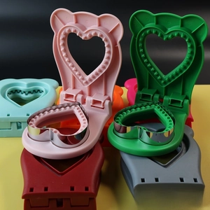 Close-up of heart and bear shaped sandwich cutters with colorful plastic grips
