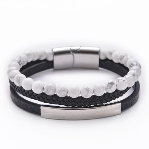 Detail of multi-layer bracelet with marble beads, braided cord, and leather metal accents