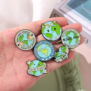 Set of 6 cartoon enamel Earth Day badges with eco-friendly slogans on a palm