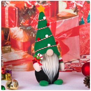 Macro detail of Christmas gnome with green hat, white beard and striped cane
