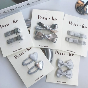 Five-piece set of stylish silver bow and glitter heart hair clips on display cards