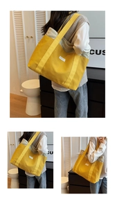 Detail of a large yellow canvas tote bag with gray stitching for college and daily use
