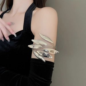 Detailed view of tiered silver leaf upper arm cuff bracelet on a model wearing black velvet