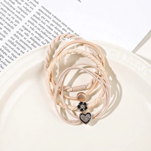 Detail of high-elasticity hair tie set featuring camellia flower and golden heart charms