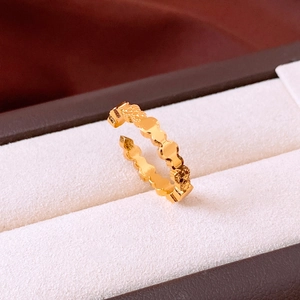 Detailed macro view of 24k gold plated ring featuring continuous bear relief patterns