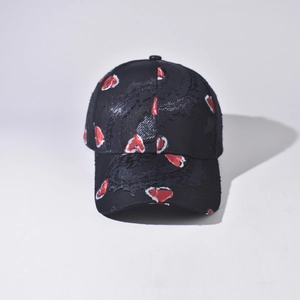 Close-up of distressed baseball cap with heart pattern and street style frayed edges