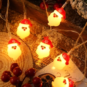 Detail showing Santa Claus LED string lights with warm yellow glow on wooden background