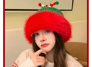 Detail of red Christmas knit hat featuring soft faux fur brim and festive pom-pom textures