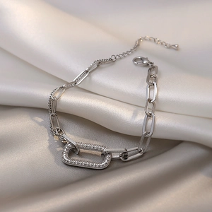 Silver geometric link chain bracelet with micro-paved cubic zirconia on satin background