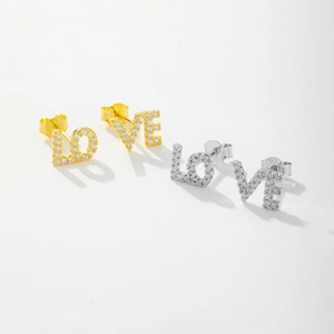 Detailed macro view of S925 silver LOVE stud earrings with pave zircon settings