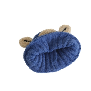 Navy blue knitted winter beanie for kids with three cute brown plush pom-poms